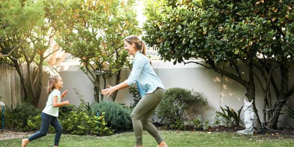 mother and daughter playing outside