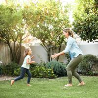 mother and daughter playing outside